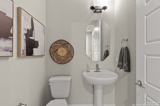 half bath featuring toilet