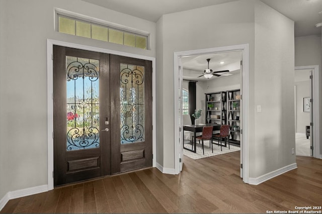 entryway featuring baseboards, ceiling fan, french doors, and wood finished floors