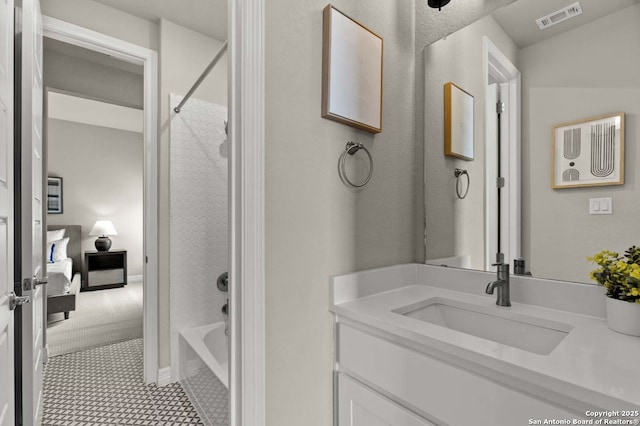 ensuite bathroom featuring ensuite bath,  shower combination, visible vents, and vanity