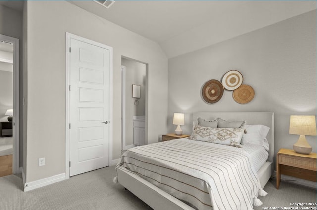bedroom with baseboards, visible vents, ensuite bathroom, and carpet