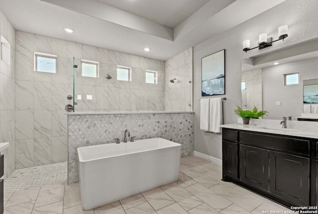 full bath featuring a walk in shower, marble finish floor, and vanity