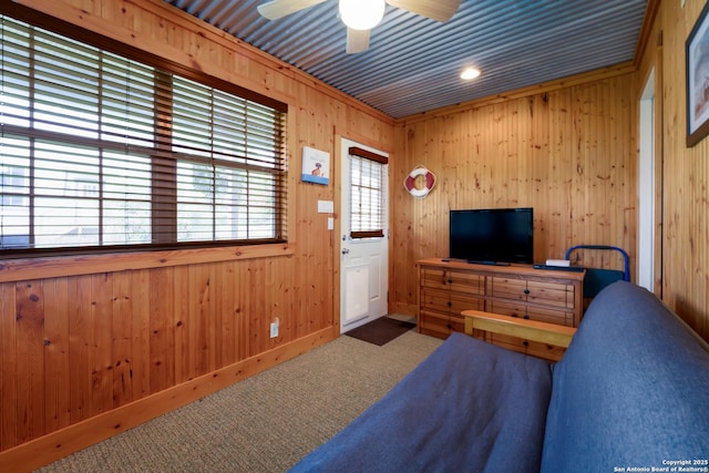 132 Clearview, Canyon Lake, TX 78133 - carpeted living room with a ceiling fan, baseboards, and wood walls