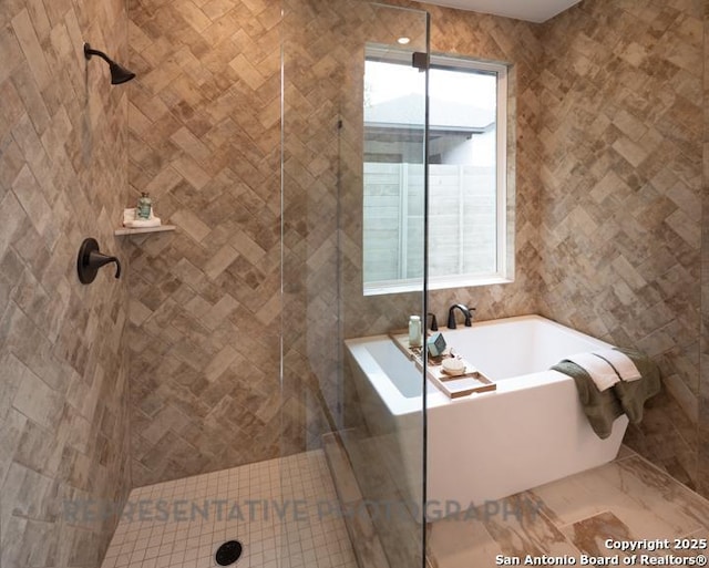 full bathroom featuring a bath, tiled shower, and tile walls