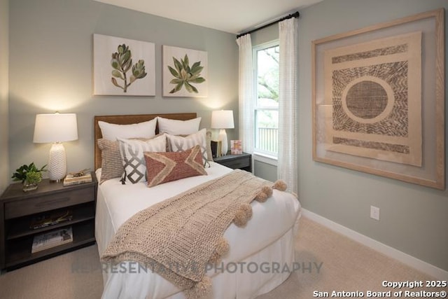 bedroom featuring baseboards and carpet flooring
