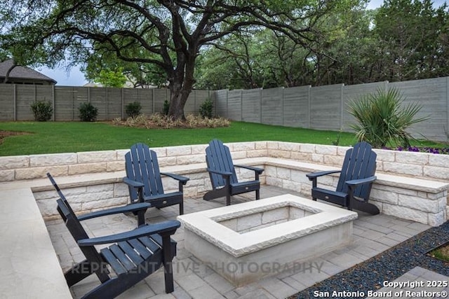 view of patio with a fenced backyard and an outdoor fire pit