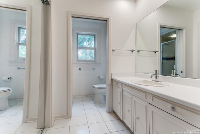 bathroom featuring vanity, tile patterned floors, toilet, and a shower stall