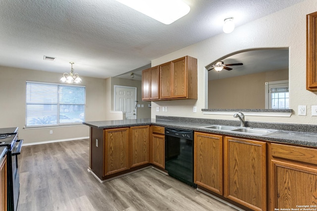 kitchen featuring dark countertops, black dishwasher, electric stove, a sink, and light wood-style flooring