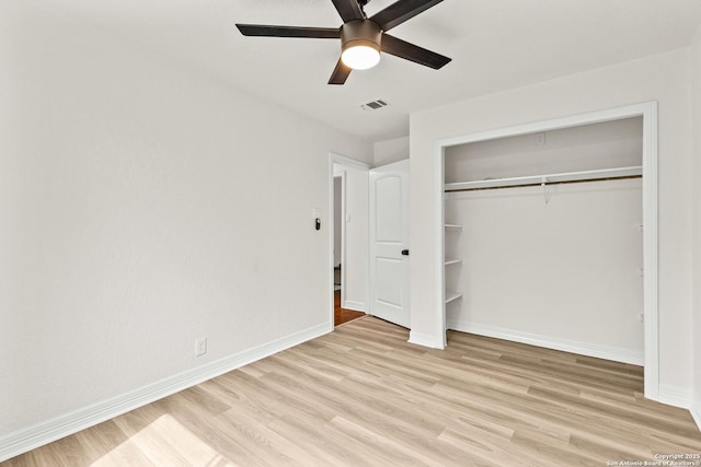 unfurnished bedroom with visible vents, a closet, baseboards, ceiling fan, and light wood finished floors