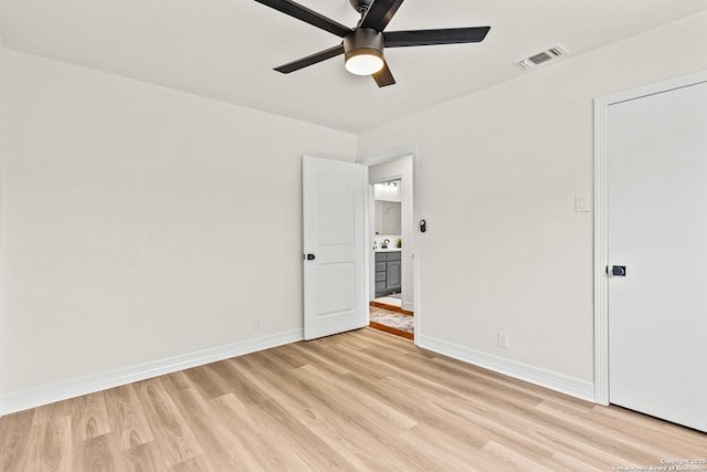 unfurnished bedroom featuring baseboards, visible vents, and light wood-style flooring
