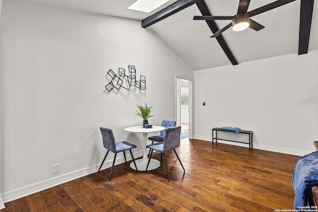 dining room with wood-type flooring, baseboards, ceiling fan, and vaulted ceiling with skylight