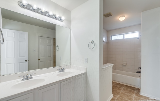 full bath featuring double vanity, visible vents, a sink, and tile patterned flooring