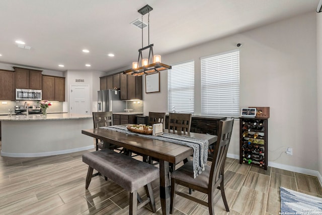 7914 Blackhawk Pass, San Antonio, TX 78253 - dining area featuring wood finish floors, recessed lighting, a chandelier, and baseboards