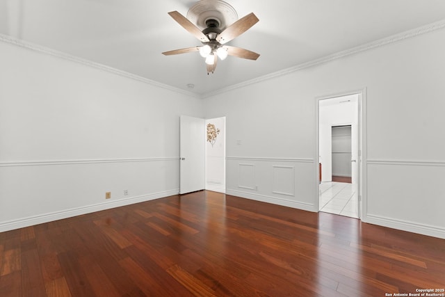 spare room featuring wood-type flooring, a ceiling fan, and crown molding