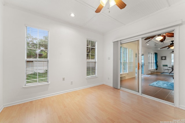 empty room featuring baseboards, ceiling fan, and wood finished floors