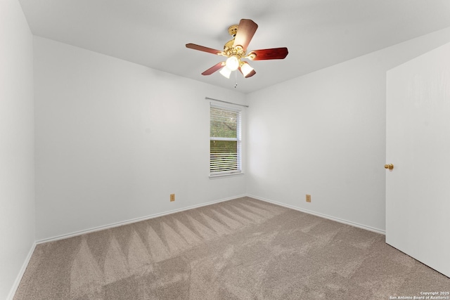 spare room with baseboards, ceiling fan, and carpet flooring