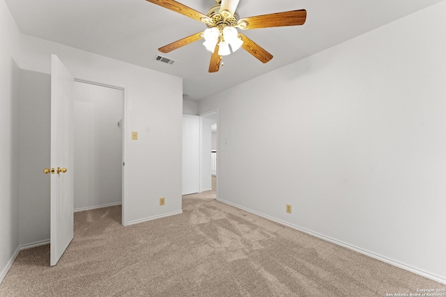 unfurnished bedroom featuring baseboards, ceiling fan, light carpet, and visible vents