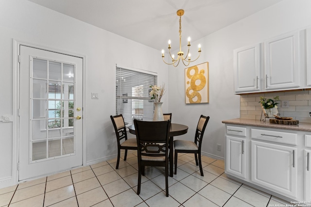 dining room featuring an inviting chandelier, baseboards, and light tile patterned flooring