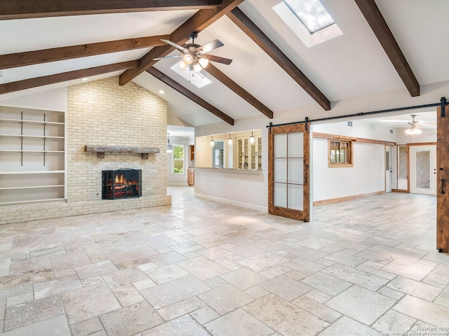 105 Sheffield, San Antonio, TX 78213 - unfurnished living room featuring a ceiling fan, a skylight, a barn door, and stone tile flooring