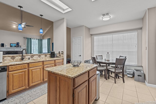 17926 Autumn Knl, San Antonio, TX 78258 - kitchen with brown cabinets, a sink, visible vents, dishwasher, and light tile patterned flooring