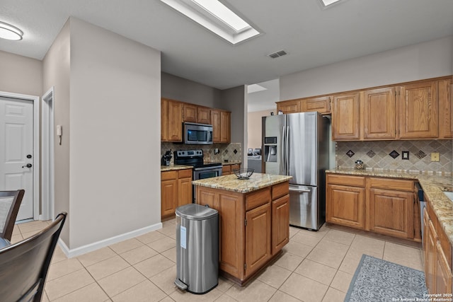 17926 Autumn Knl, San Antonio, TX 78258 - kitchen featuring light stone countertops, visible vents, light tile patterned flooring, tasteful backsplash, and appliances with stainless steel finishes