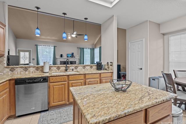 17926 Autumn Knl, San Antonio, TX 78258 - kitchen featuring light stone counters, a sink, and stainless steel dishwasher