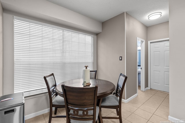 17926 Autumn Knl, San Antonio, TX 78258 - dining space featuring light tile patterned floors, baseboards, and a textured ceiling
