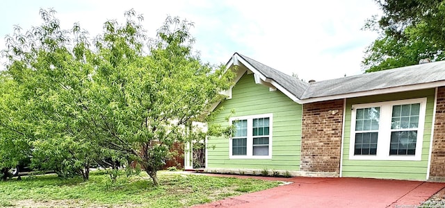 view of home's exterior featuring a patio area and brick siding