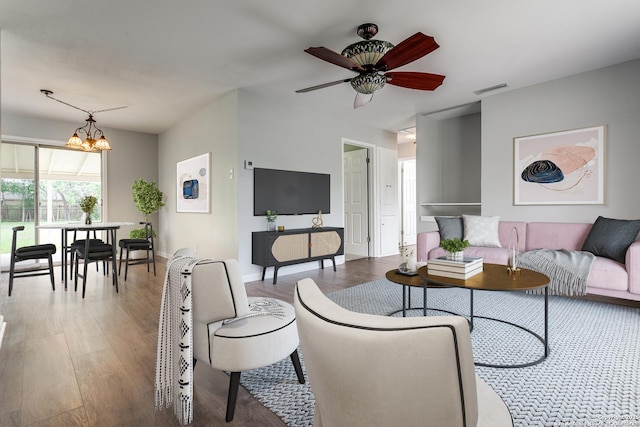 209 Ivy Ln, Universal City, TX 78148 - living room featuring ceiling fan with notable chandelier, wood finished floors, and visible vents