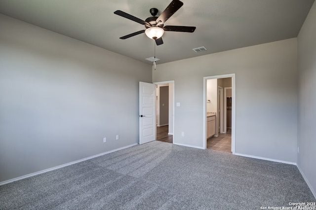unfurnished bedroom featuring visible vents, light carpet, baseboards, ceiling fan, and connected bathroom