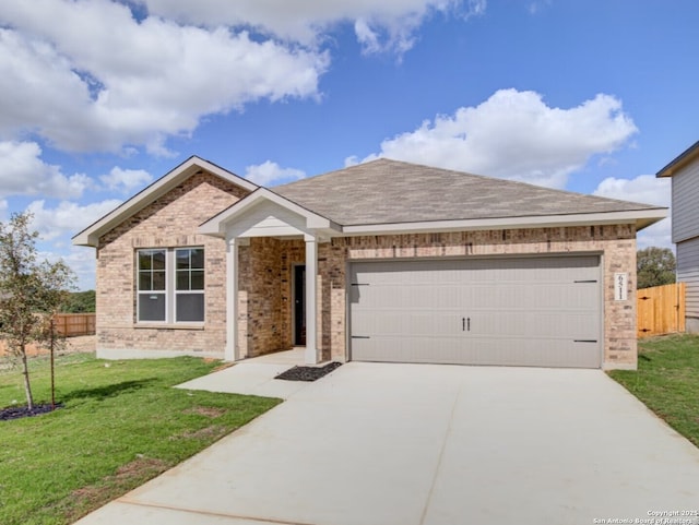 ranch-style house featuring fence, a front lawn, brick siding, a garage, and driveway