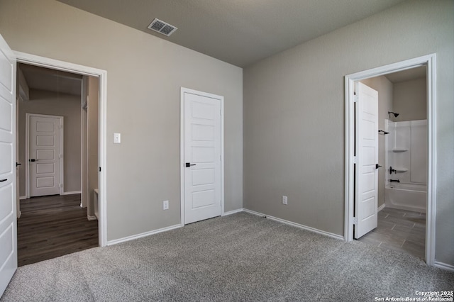 unfurnished bedroom with baseboards, carpet, and visible vents