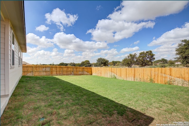 view of yard with a fenced backyard