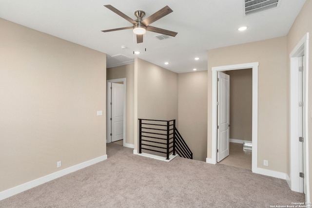 spare room with baseboards, a ceiling fan, carpet flooring, and visible vents