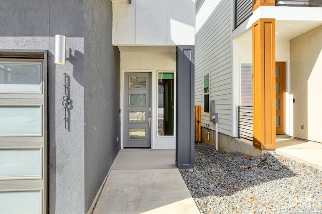entrance to property featuring stucco siding