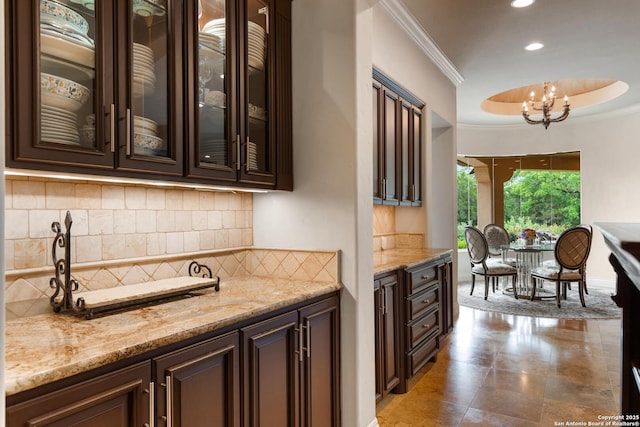 bar with crown molding, a notable chandelier, recessed lighting, decorative backsplash, and pendant lighting