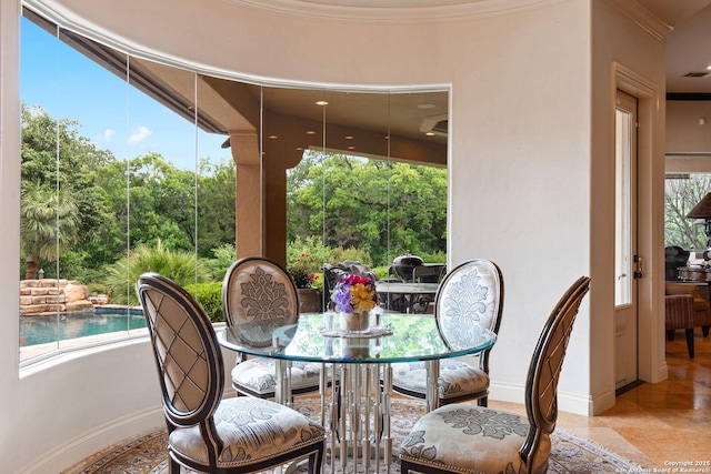 dining area with baseboards and ornamental molding
