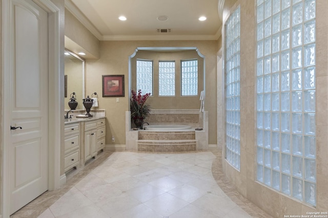 full bathroom featuring crown molding, visible vents, a garden tub, and vanity