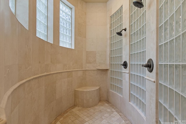 full bathroom with tile patterned floors and a tile shower