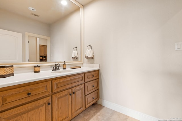 bathroom featuring visible vents, baseboards, tile patterned floors, and vanity