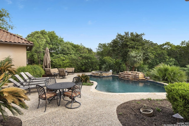view of pool featuring a patio area and a pool with connected hot tub