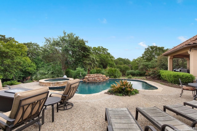 outdoor pool featuring a patio and an in ground hot tub