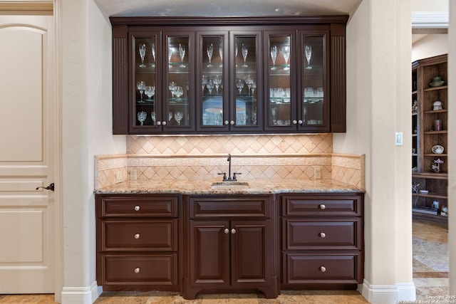 bar with a sink and backsplash