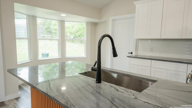 5806 Gillis, San Antonio, TX 78240 - interior details featuring a sink, dark stone countertops, white cabinets, and tasteful backsplash