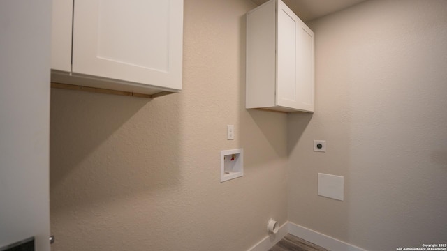 5806 Gillis, San Antonio, TX 78240 - laundry room with cabinet space, hookup for a washing machine, electric dryer hookup, baseboards, and wood finished floors