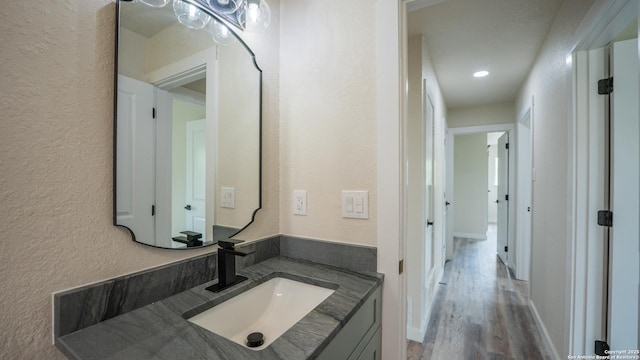 5806 Gillis, San Antonio, TX 78240 - bathroom featuring recessed lighting, a textured wall, wood finished floors, and vanity