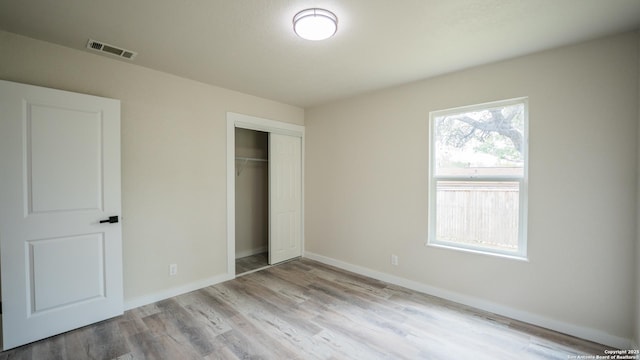 5806 Gillis, San Antonio, TX 78240 - unfurnished bedroom with baseboards, a closet, wood finished floors, and visible vents