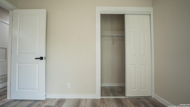 5806 Gillis, San Antonio, TX 78240 - unfurnished bedroom featuring a closet, baseboards, wood finished floors, and visible vents