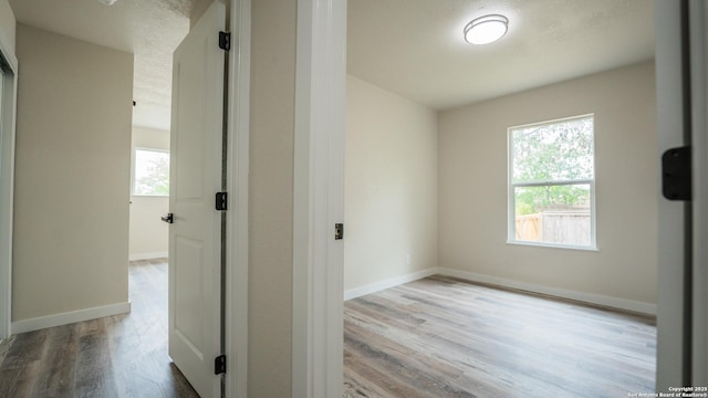 5806 Gillis, San Antonio, TX 78240 - hallway featuring baseboards, a wealth of natural light, and wood finished floors