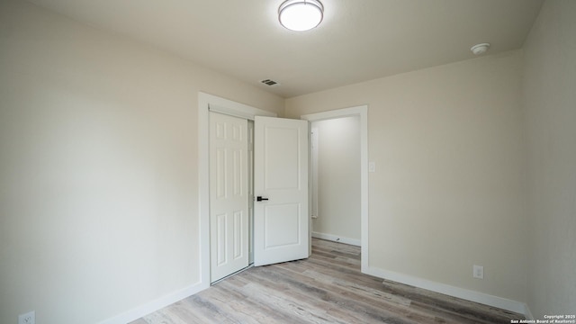 5806 Gillis, San Antonio, TX 78240 - unfurnished bedroom featuring visible vents, light wood-style floors, baseboards, and a closet