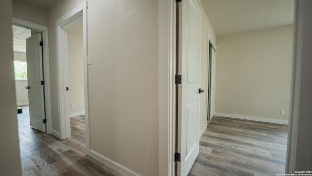 5806 Gillis, San Antonio, TX 78240 - hallway featuring baseboards and wood finished floors